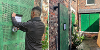 Two images side by side - the left shows an enforcement officer attaching a Closure Order notice to a boarded up door of a house on Yarm Road. The right shows the boarded up door plus boarded up windows. All are covered by green metal barriers.