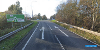 A Google Streetview image of the approach to the Elton Interchange roundabout, just off the A66. The two lane road has arrows in each lane and the roundabout can be seen in the background. A road sign on the left denotes the approaching roundabout.