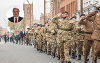 A Remembrance Day parade with a headshot of the Council's Leader, Councillor Bob Cook