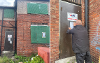 Council officer putting up an order on a building