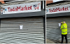 Shutters down on shop front with closure order being added