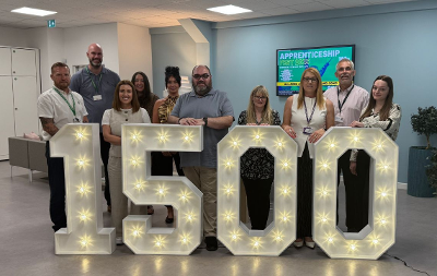Employment and Training Hub staff standing around 1500 number lights 