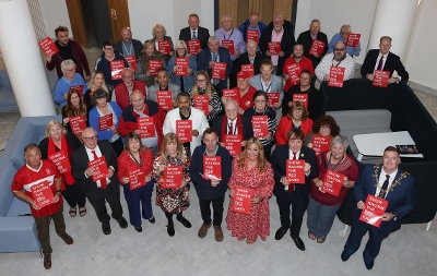 Stockton-on-Tees Borough Council Councillors stood together holding Show Racism the Red Card signs