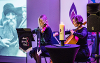 Image of remembrance candle and Arco String Duo playing at Holocaust Memorial event